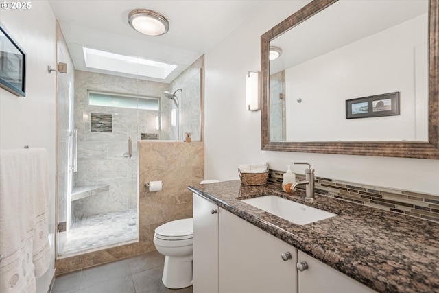 515 SW Colony Dr, Portland, OR 97219 - bathroom with toilet, vanity, a skylight, and a stall shower