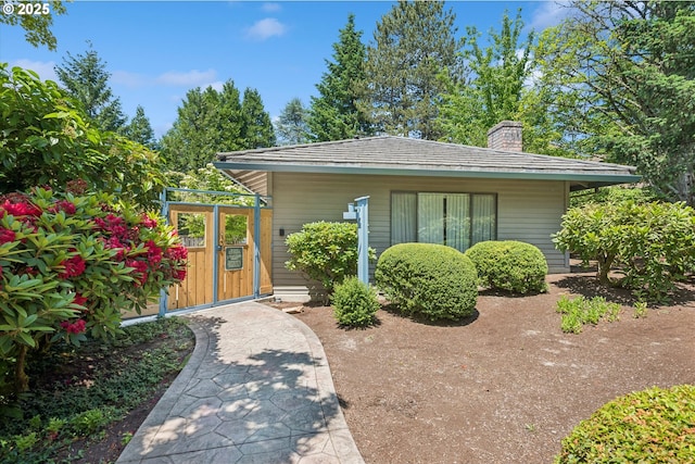515 SW Colony Dr, Portland, OR 97219 - view of front of property featuring a chimney and a gate