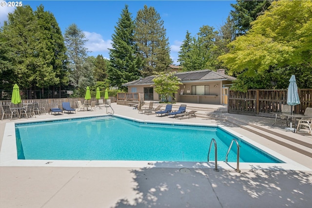 515 SW Colony Dr, Portland, OR 97219 - community pool featuring a patio area and view of scattered trees