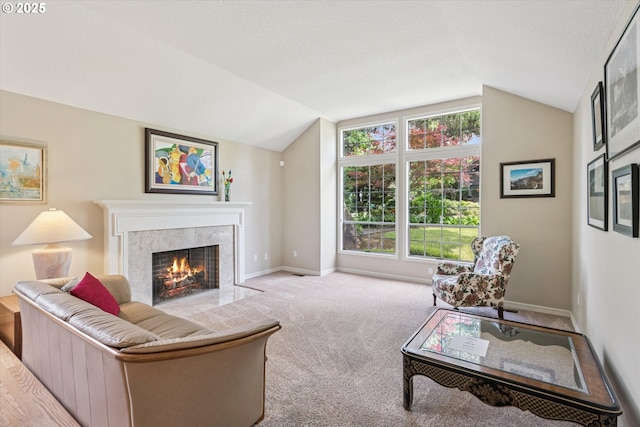 515 SW Colony Dr, Portland, OR 97219 - carpeted living room featuring vaulted ceiling, a premium fireplace, and baseboards