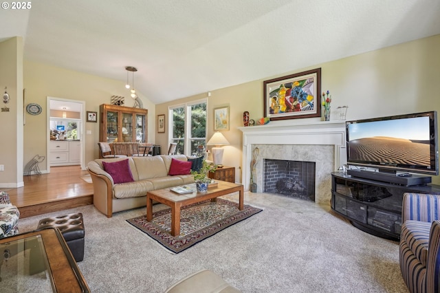 515 SW Colony Dr, Portland, OR 97219 - living room featuring a high end fireplace, lofted ceiling, and carpet floors