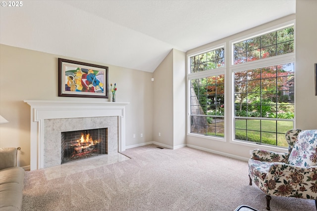 515 SW Colony Dr, Portland, OR 97219 - living area featuring a premium fireplace, lofted ceiling, carpet, and baseboards