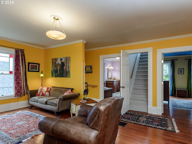 living room featuring hardwood / wood-style flooring and crown molding