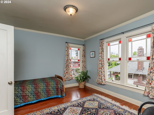 bedroom with hardwood / wood-style flooring and ornamental molding