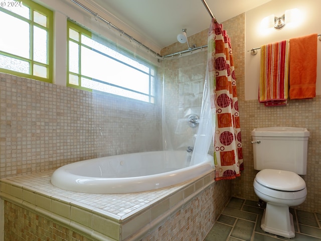 bathroom featuring tile walls, shower / bath combo, and toilet