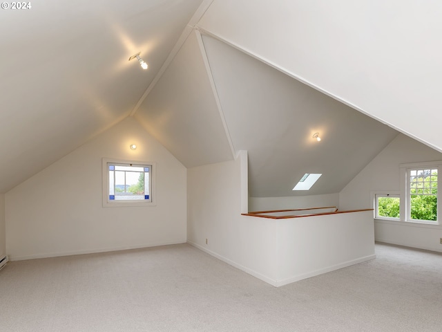 bonus room with light carpet and vaulted ceiling