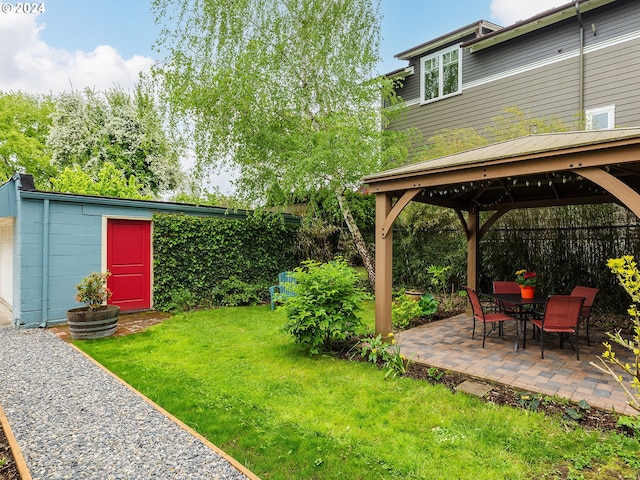 view of yard with a gazebo, an outbuilding, and a patio