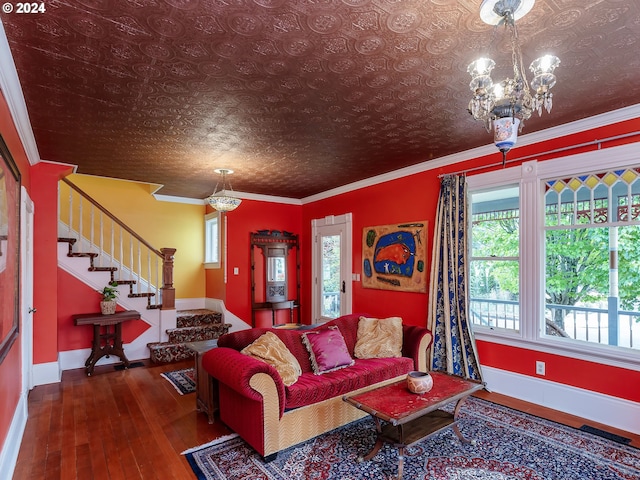 living room with crown molding, dark hardwood / wood-style floors, and a notable chandelier