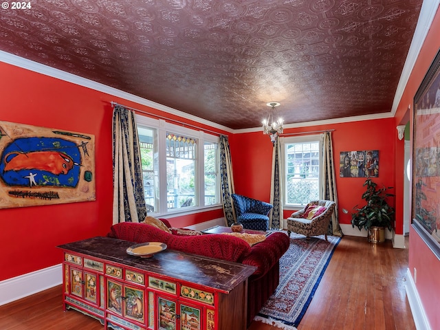 living room with crown molding, a healthy amount of sunlight, and hardwood / wood-style flooring