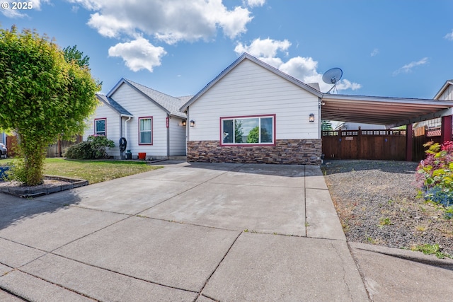 930 Hammer St, Harrisburg, OR 97446 - view of front of home with an attached carport, stone siding, and driveway