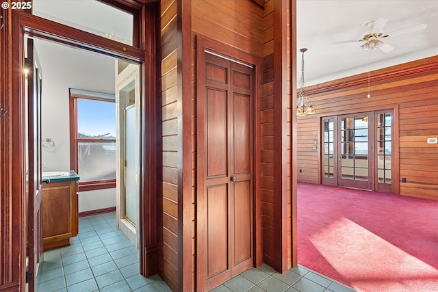 155 N 6th Ave, Elgin, OR 97827 - corridor featuring wooden walls, tile patterned flooring, and carpet floors