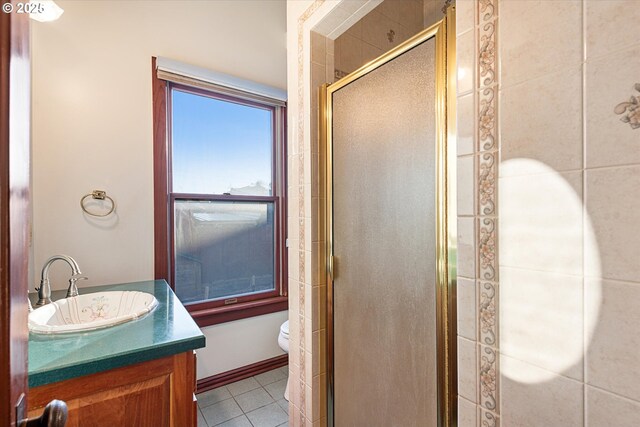 155 N 6th Ave, Elgin, OR 97827 - bathroom with a stall shower, tile patterned floors, vanity, and toilet