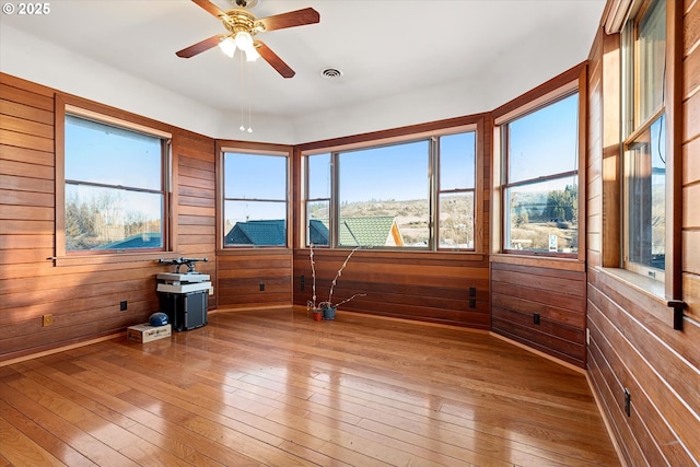 155 N 6th Ave, Elgin, OR 97827 - spare room featuring wood-type flooring, wood walls, and a ceiling fan