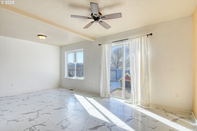 unfurnished room featuring ceiling fan and beam ceiling