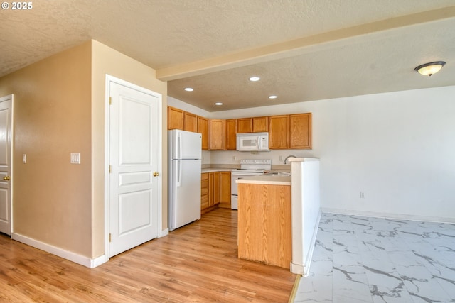 kitchen featuring sink, a textured ceiling, and white appliances