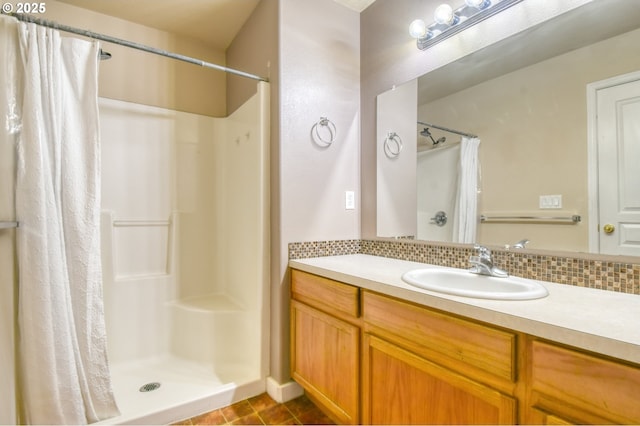 bathroom with vanity, curtained shower, and backsplash