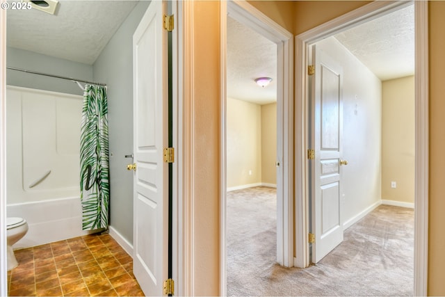 interior space with carpet floors and a textured ceiling