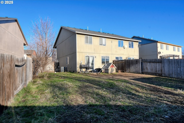 back of property featuring a yard