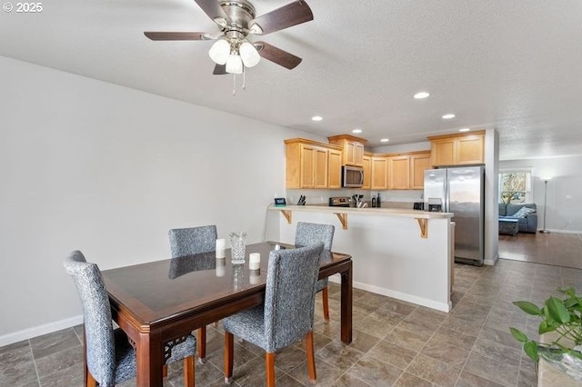 dining space featuring ceiling fan, baseboards, a textured ceiling, and recessed lighting