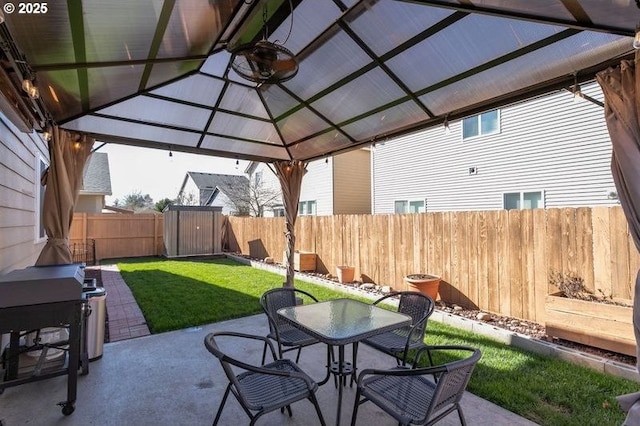 view of patio / terrace featuring outdoor dining space, a fenced backyard, and a gazebo