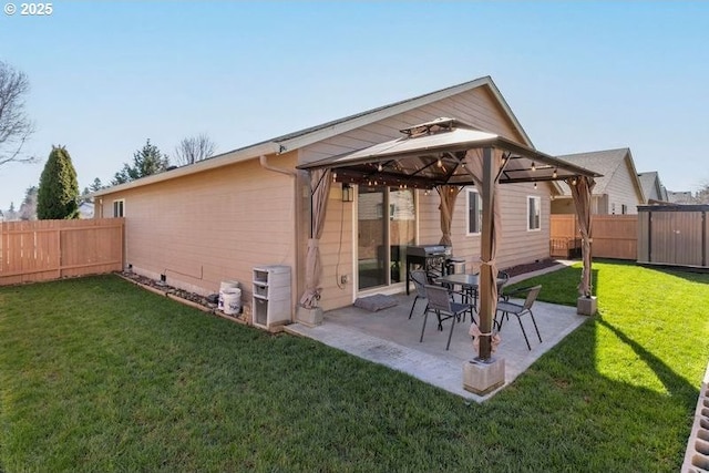 back of property featuring a gazebo, a yard, a patio, and a fenced backyard