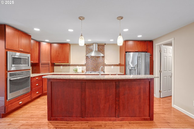 17616 SW Ivy Glenn Dr, Beaverton, OR 97007 - kitchen with stainless steel appliances, wall chimney range hood, light wood-type flooring, tasteful backsplash, and decorative light fixtures