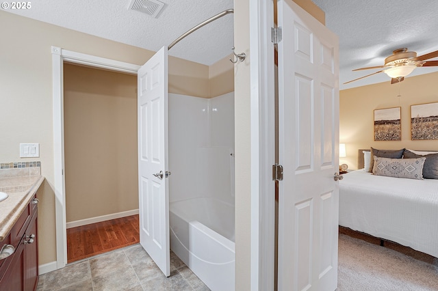 17616 SW Ivy Glenn Dr, Beaverton, OR 97007 - ensuite bathroom with vanity, a textured ceiling, a ceiling fan, and shower / bath combination