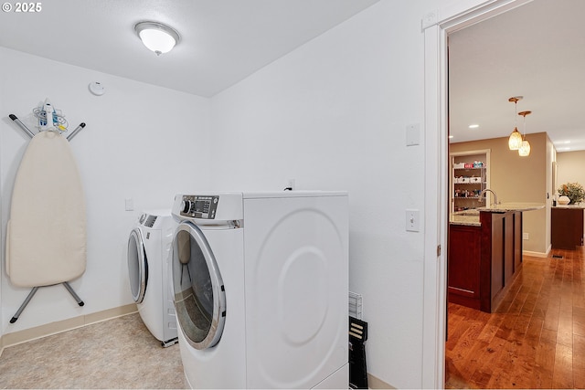 17616 SW Ivy Glenn Dr, Beaverton, OR 97007 - laundry area with independent washer and dryer and light wood-type flooring