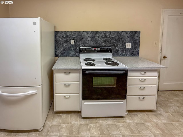 kitchen with freestanding refrigerator, backsplash, light countertops, and electric range