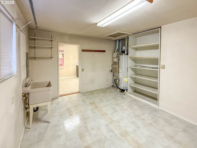 below grade area featuring light floors and gas water heater