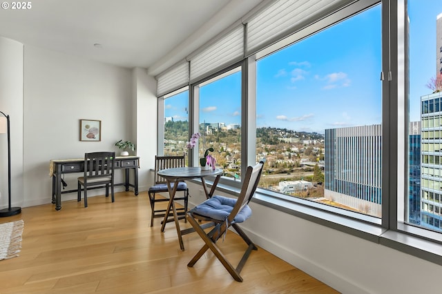 sunroom featuring a city view