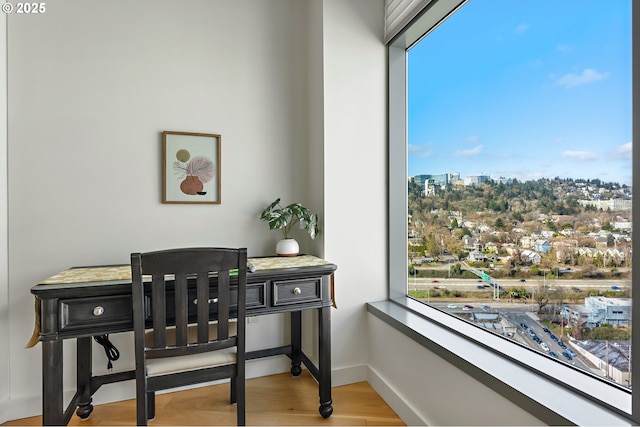 dining area featuring baseboards and wood finished floors