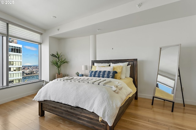 bedroom with wood finished floors and baseboards