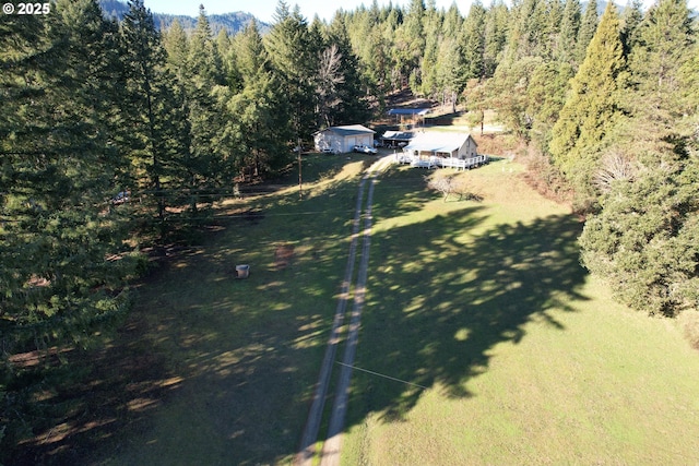 aerial view of property and surrounding area with a forest