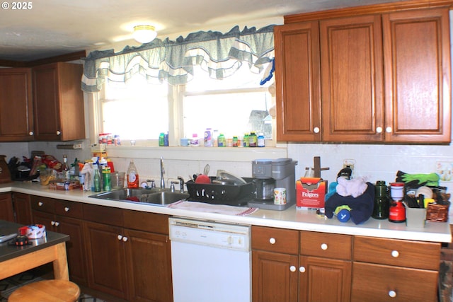 kitchen with dishwasher, decorative backsplash, and sink