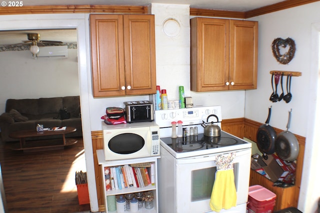 kitchen featuring white appliances, ceiling fan, wood walls, a wall mounted AC, and crown molding