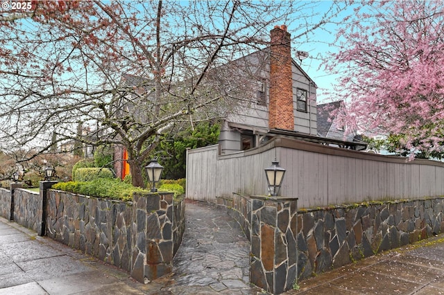 view of property exterior featuring a chimney