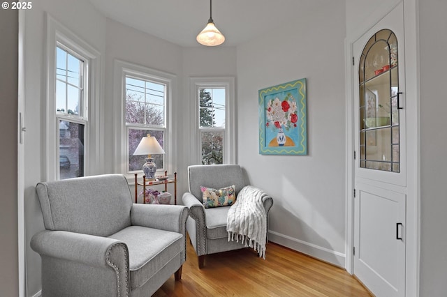 sitting room featuring light wood-style flooring and baseboards