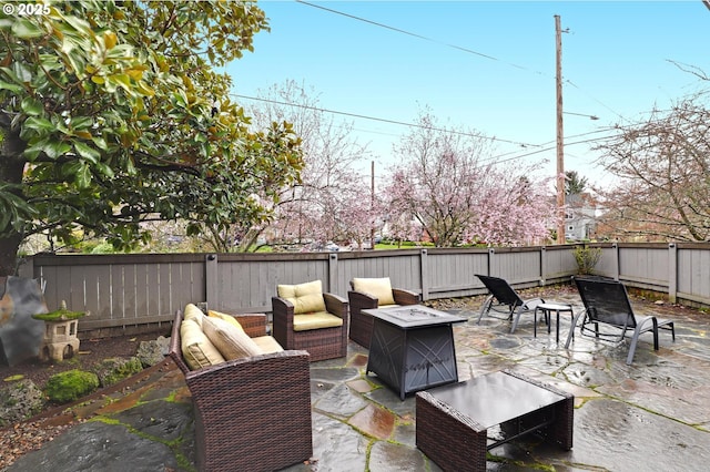 view of patio with a fenced backyard and an outdoor fire pit