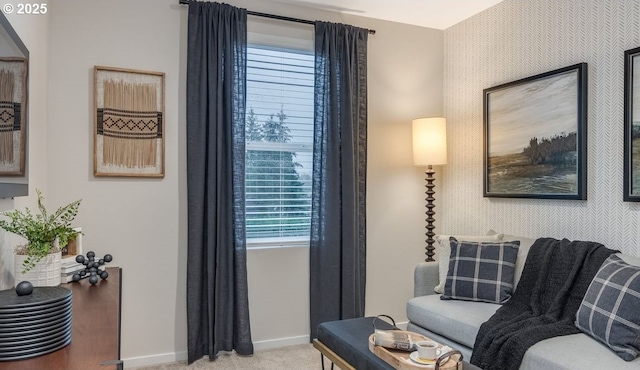 interior space with baseboards, light carpet, and wallpapered walls