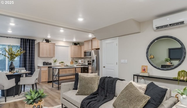 living area with recessed lighting, a wall mounted air conditioner, and light wood-style flooring