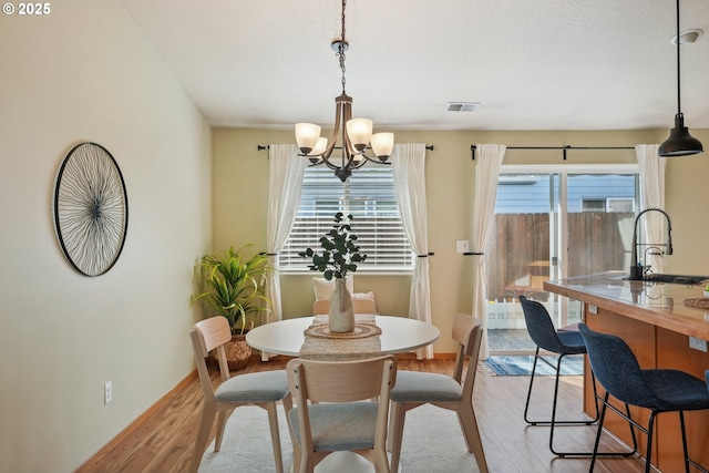 2383 SE 61st Ln, Hillsboro, OR 97123 - dining space with wood finished floors and a chandelier