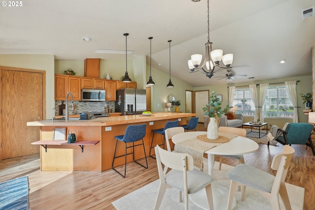 2383 SE 61st Ln, Hillsboro, OR 97123 - dining area featuring a chandelier, lofted ceiling, light wood finished floors, ceiling fan, and recessed lighting