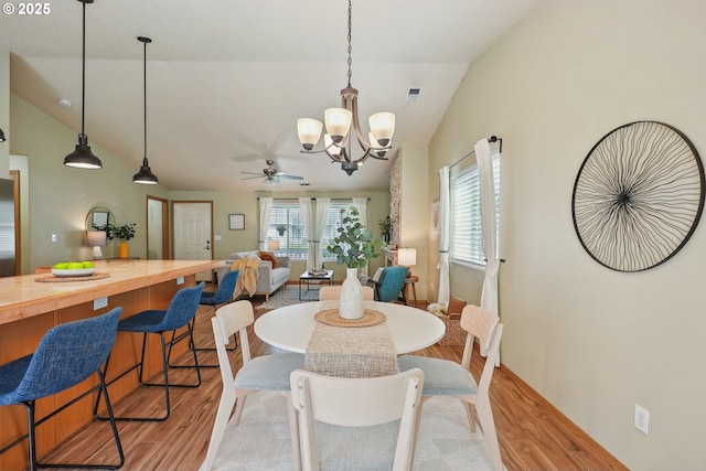 2383 SE 61st Ln, Hillsboro, OR 97123 - dining space featuring lofted ceiling, light wood-style flooring, a chandelier, and a ceiling fan