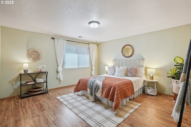 2383 SE 61st Ln, Hillsboro, OR 97123 - bedroom featuring a textured ceiling, wood finished floors, and baseboards