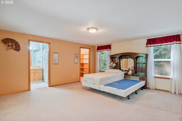 230 S Maple Hill Rd, Kelso, WA 98626 - carpeted bedroom featuring baseboards, a textured ceiling, and connected bathroom