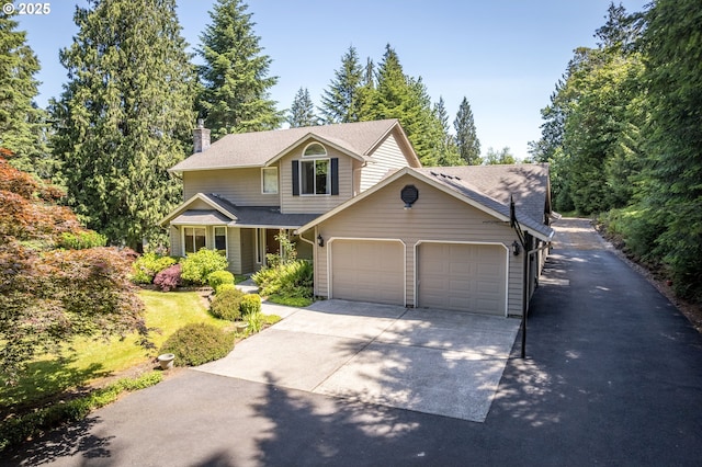 230 S Maple Hill Rd, Kelso, WA 98626 - traditional-style house with a garage, a chimney, concrete driveway, and a shingled roof