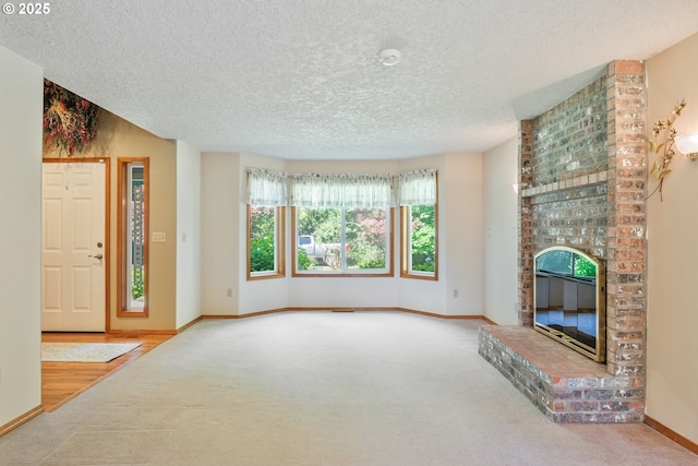 230 S Maple Hill Rd, Kelso, WA 98626 - unfurnished living room featuring carpet flooring, a textured ceiling, a brick fireplace, and baseboards