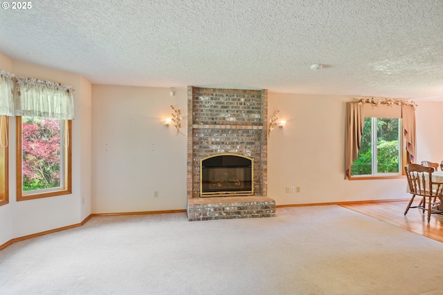 230 S Maple Hill Rd, Kelso, WA 98626 - unfurnished living room featuring a textured ceiling, a fireplace, carpet, and baseboards