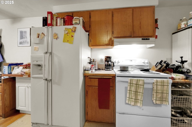 kitchen with light countertops, white appliances, brown cabinetry, and under cabinet range hood